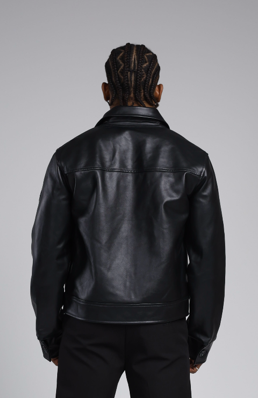 Man wearing a the 244 angels at heart black cowhide leather jacket and pants on a grey background. Back view half-body shot
