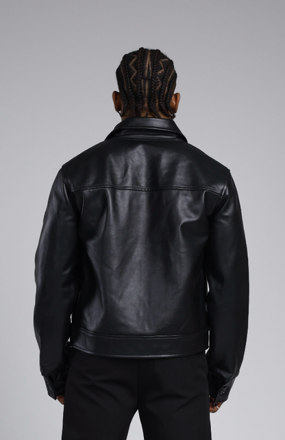 Man wearing a the 244 angels at heart black cowhide leather jacket and pants on a grey background. Back view half-body shot
