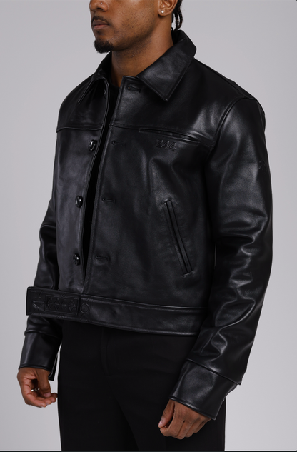 Man wearing a the 244 angels at heart black cowhide leather jacket and pants on a grey background. Half body shot